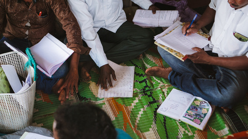 People sitting and taking notes together