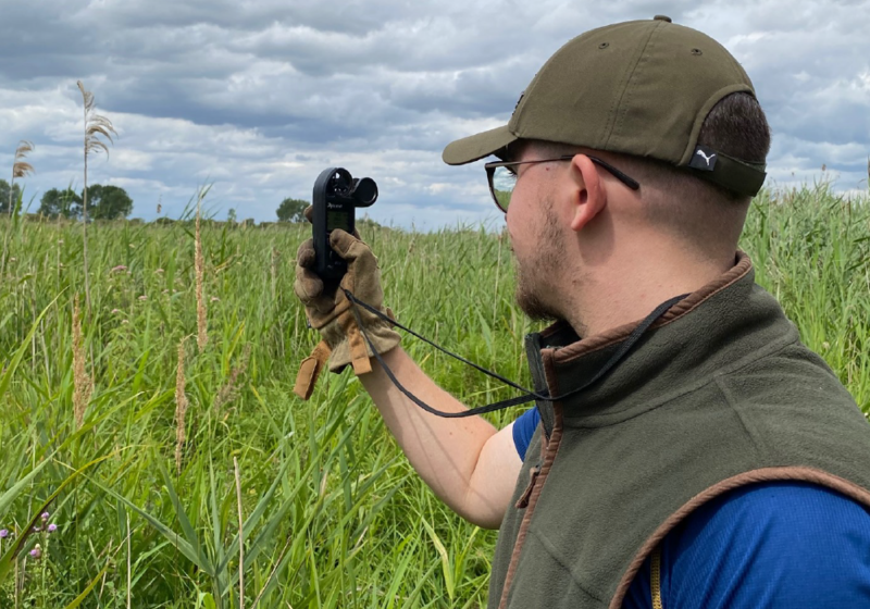 Neil Mahon takes readings in field